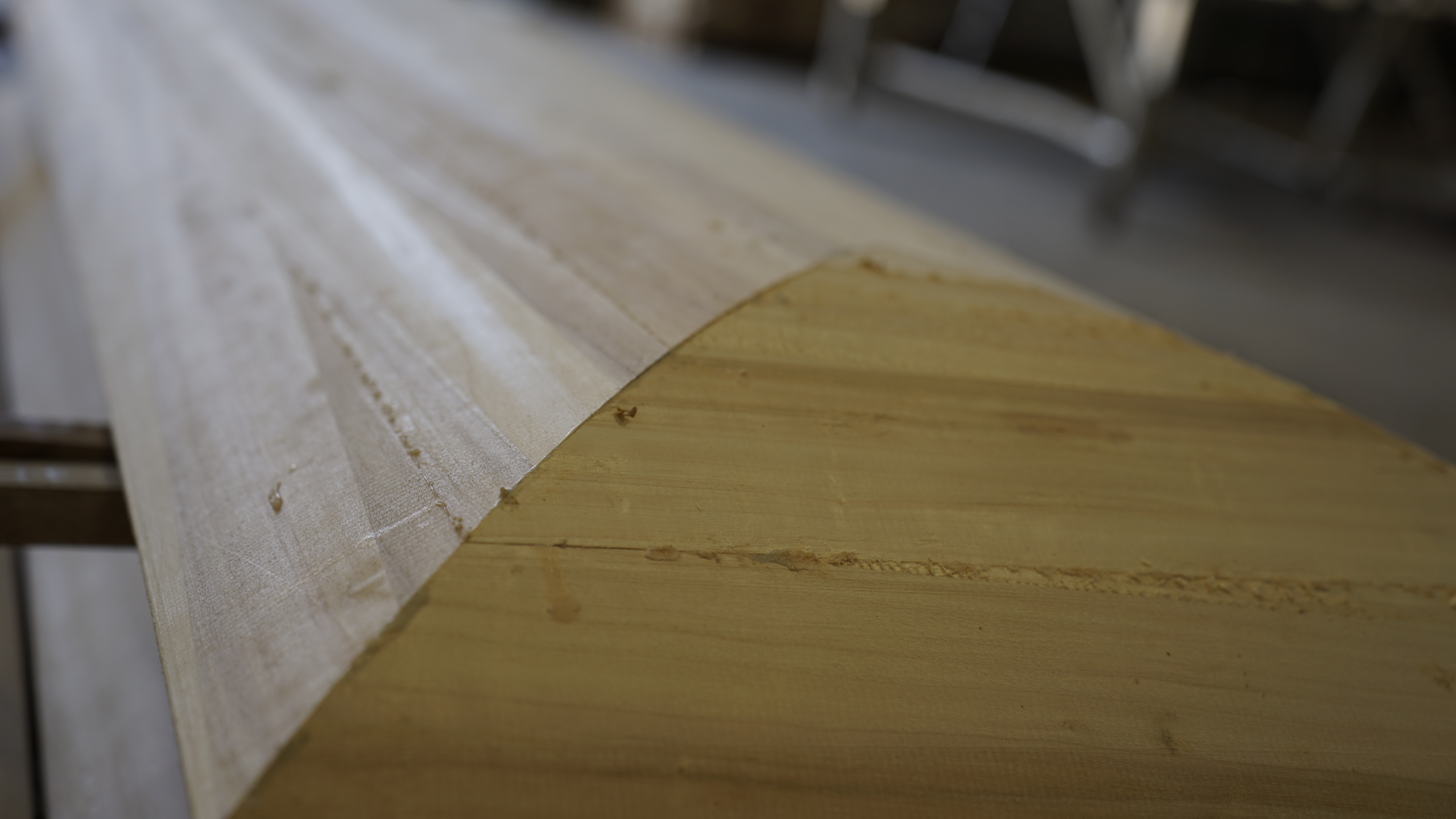 Close-up of sanding station showing fine detail work on casket moulding